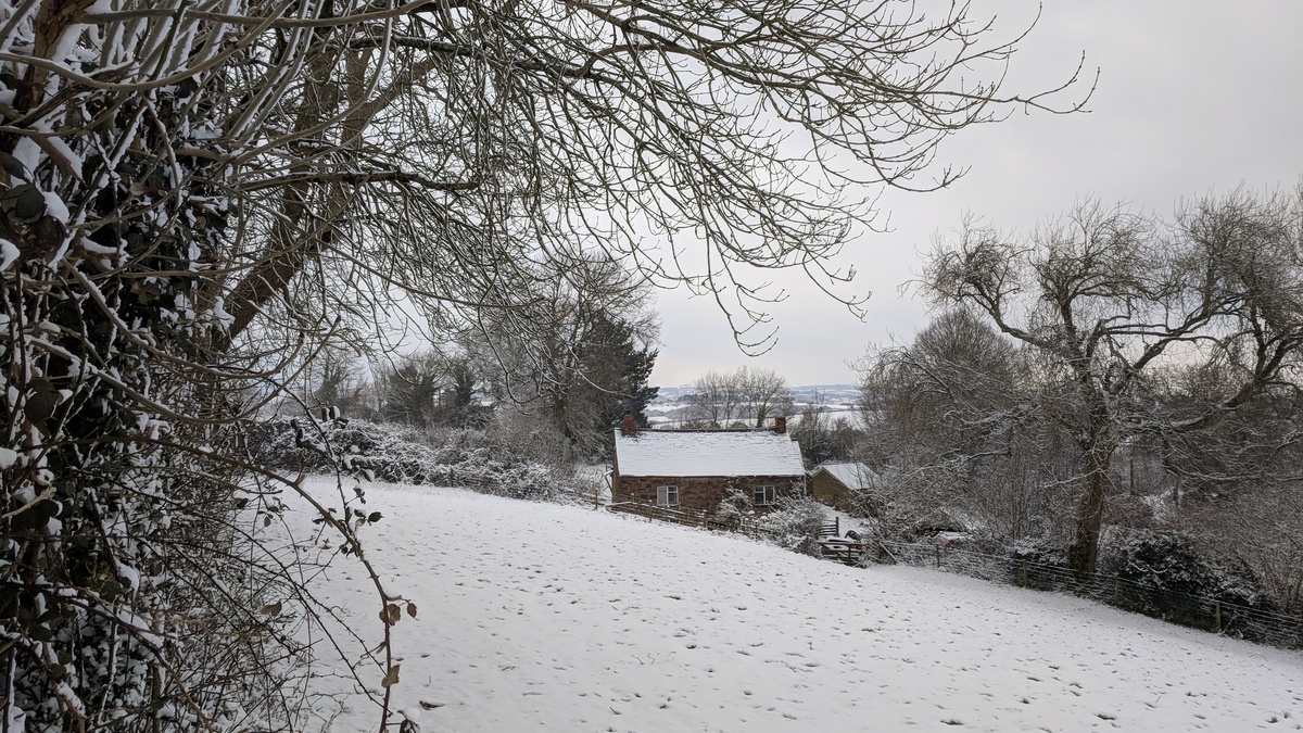 A small old country house in a snowy landscape